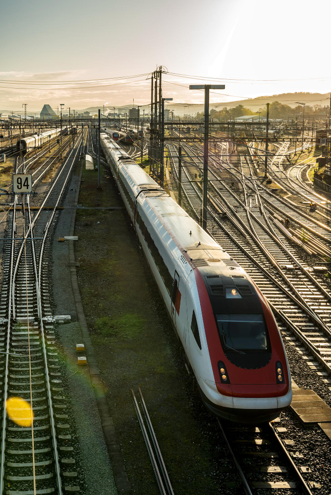 Train travelling on railway tracks viewed from above